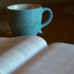 Bible open with coffee mug