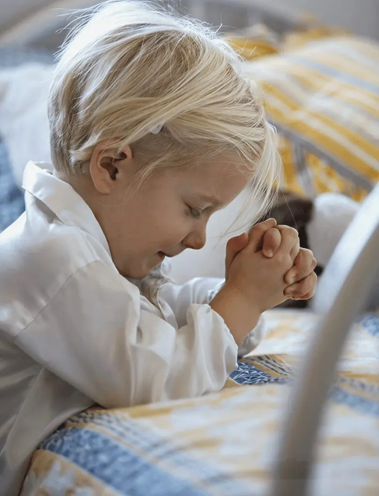 Blonde child with clasped hands