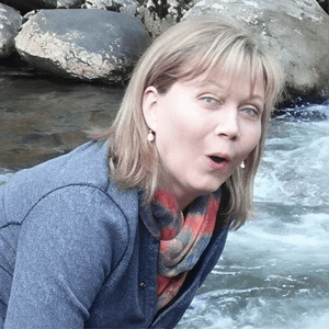Woman by a rocky riverbank