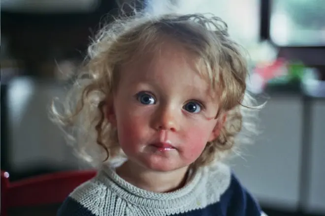 Curly-haired toddler with big blue eyes