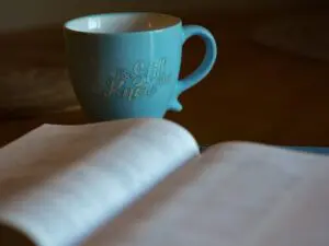 Inspirational mug near open book