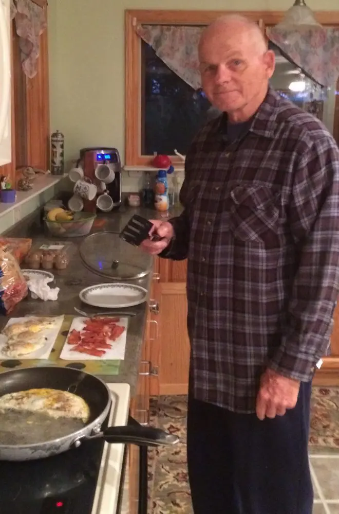 Man cooking breakfast in kitchen