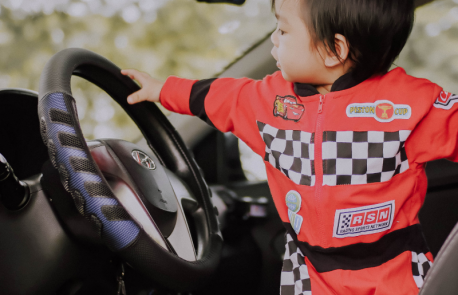 child-holding-steering-wheel
