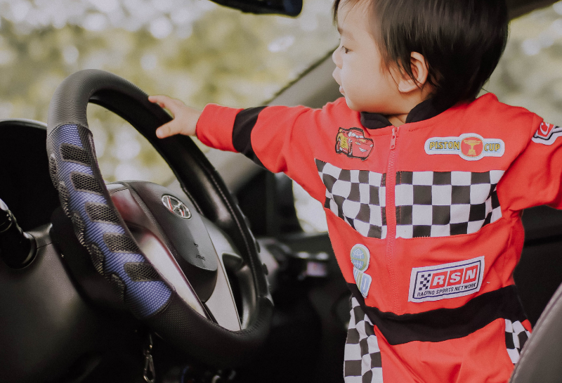 child-holding-steering-wheel